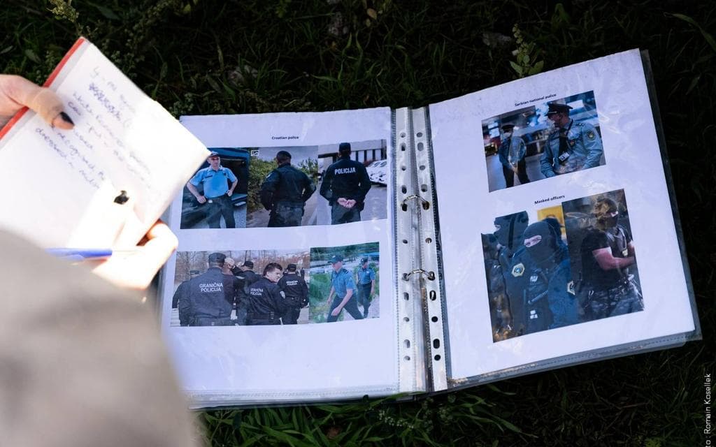 The picture shows a photo book with four pictures on which police and border guards are portrayed. Additionally, tn the left side, a hand is holding a paper with notes.
